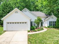 Charming single-story home with a two-car garage and a well-manicured lawn at 8623 Cedar Hollow Ln, Huntersville, NC 28078