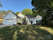 Charming single-story home with manicured lawn, attached garage, and inviting curb appeal at 8623 Cedar Hollow Ln, Huntersville, NC 28078