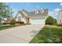 Charming home featuring a two-car garage, dormer windows, and a well-manicured front lawn at 117 Pine Lake Dr, Monroe, NC 28110