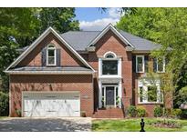 Beautiful brick home with attached two-car garage and manicured lawn, offering classic curb appeal at 1305 Foxfield Rd # 60, Waxhaw, NC 28173