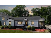 Charming one-story home with black and white trim, and a well-manicured front yard at 2138 Revolution Park Dr, Charlotte, NC 28208