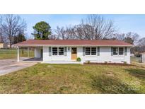 Charming single-story home with white brick, a red roof, and well-maintained lawn at 2232 Glenraven Ave, Gastonia, NC 28052