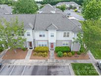 Charming townhouse with landscaped front yard, neutral siding, and gray shingle roof at 2388 Loch Stone Dr # E, Gastonia, NC 28054