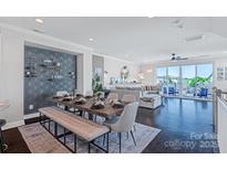 Bright dining room and living room with a modern open floor plan and access to a large outdoor patio at 2551 Statesville Ave, Charlotte, NC 28206