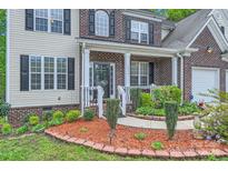 Charming brick-accented home with a cozy front porch and manicured landscaping at 10836 Maryanna Ct, Charlotte, NC 28213