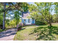 Charming home featuring blue shutters, a welcoming entrance, and mature trees on a spacious lot at 11024 Hunters Trace None, Charlotte, NC 28262
