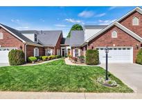 Charming brick home featuring manicured lawn and lush landscaping with a two-car garage and inviting entryway at 1119 21St Ne Ave, Hickory, NC 28601