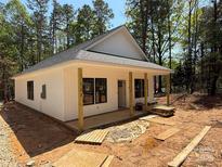 Charming single-story home featuring white siding, a covered front porch, and large windows at 148 Forest Meadow Ln, Salisbury, NC 28144