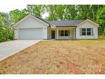 Charming single-story home with white siding, gray shutters, attached garage, and newly seeded front lawn at 164 Hillndale Ln, Statesville, NC 28677