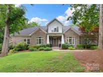 Charming brick home featuring a manicured lawn and well-maintained landscaping, with flowering bushes in the front yard at 206 Oxford Place Dr, Fort Mill, SC 29715