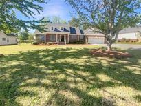 Charming brick home with a large front yard, mature trees, and inviting curb appeal at 249 Arrowood Ave, Lancaster, SC 29720