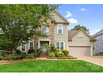 Charming home featuring brick and siding exterior, manicured landscaping, and a welcoming front entrance at 2710 Providence Spring Ln, Charlotte, NC 28270