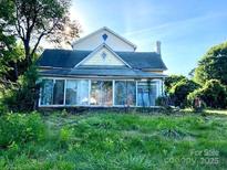 A charming two-story home with a sunroom, perfect for relaxation at 6000 S Main St, Salisbury, NC 28147