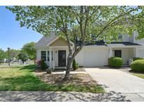 Charming townhome featuring a well-maintained yard and an attached one car garage at 6631 Vlosi Dr, Charlotte, NC 28226