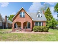 Charming brick home featuring a classic design, a welcoming front porch, and a well-maintained lawn at 709 Myrtle Dr, Rock Hill, SC 29730