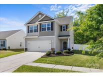 Attractive exterior view of a well-maintained two-story home showcasing a manicured lawn and attached two-car garage at 7113 Amberly Hills Rd, Charlotte, NC 28215