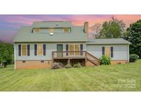 Charming two-story home featuring a welcoming deck and well-maintained lawn at 109 Terrace Pl, Lincolnton, NC 28092