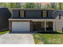 Charming two-story home with stone accents, a welcoming front porch, and a well-manicured lawn at 1336 26Th Ne Ave, Hickory, NC 28601