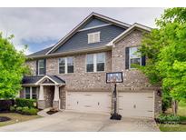 Beautiful two-story brick home with a two-car garage and well-maintained landscaping at 1446 Cilantro Ct, Tega Cay, SC 29708
