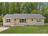 Charming single-story home with a well-manicured lawn and neutral-toned brick and vinyl siding at 145 Burton Hills Cir, Gastonia, NC 28054