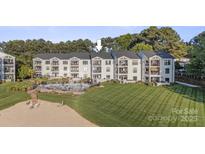 Beautiful waterfront condo building with private beach access and a pool overlooking the lake at 17810 Half Moon Ln # L, Cornelius, NC 28031