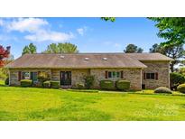 Charming ranch-style brick home with manicured lawn and mature landscaping at 189 Billy Jo Rd, Mooresville, NC 28117
