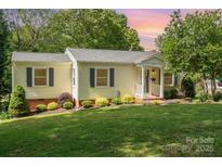 Charming one-story home with manicured lawn and flowering bushes at 204 Myers St, Fort Mill, SC 29715