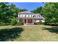 Charming two-story home with a landscaped front yard, inviting porch, and classic architectural details at 2153 Darian Way, Waxhaw, NC 28173