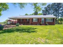 Charming brick home with a well-maintained lawn and inviting front porch at 3340 Wrenwood Dr, Newton, NC 28658