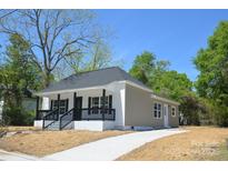 Charming single-story home with a welcoming front porch and newly paved driveway at 406 W Marion St, Kershaw, SC 29067