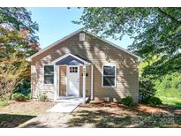 Charming single-story home featuring tan siding, white trim and a cozy covered entrance at 602 Childs St, Lincolnton, NC 28092