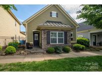 Charming home featuring a combination of stone and shingle siding, complemented by manicured landscaping at 6029 Bountiful St, Belmont, NC 28012