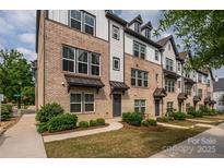 Charming townhomes featuring brick and siding accents, landscaped yards, and inviting curb appeal at 604 Tudor Park Way, Charlotte, NC 28211