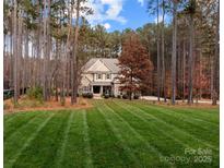 Charming home with manicured lawn, mature trees, and a welcoming facade in a picturesque setting at 109 Trent Pines Dr, Mooresville, NC 28117