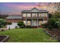 Charming two-story brick home with a well-manicured lawn and inviting front porch at 110 Overhill Dr, Salisbury, NC 28144