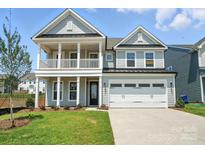 Charming two-story home with a welcoming front porch and attached two-car garage at 119 Longwood Rd # 62, Mooresville, NC 28115