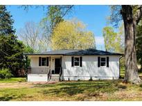Ranch style home with dark shutters and trim, new roof, and front porch at 188 Bailey Rd, Mooresville, NC 28117
