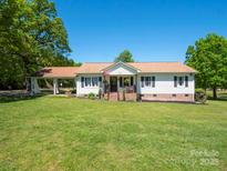 Charming single-story home with a well-manicured lawn and cozy covered front porch at 2008 Faulkner Rd, Clover, SC 29710