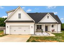 Charming two-story home with white siding, covered porch, and well-manicured lawn. Perfect for curb appeal and relaxed outdoor living at 2119 Smith Rd, Clover, SC 29710