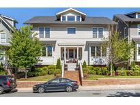 Charming two-story home features a symmetrical facade, manicured landscaping, and inviting front porch with seating at 2500 Marshall Pl, Charlotte, NC 28203