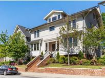 Inviting two-story home featuring a brick-lined staircase, complemented by landscaped greenery and a classic architectural design at 2500 Marshall Pl, Charlotte, NC 28203