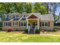 Charming single-Gathering home with manicured lawn, dormer windows and inviting front entrance at 4467 Woodlark Ln, Charlotte, NC 28211
