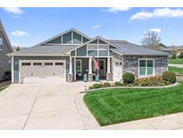 Inviting home featuring a well-manicured lawn, a two-car garage, and stone and siding details at 5103 Looking Glass Trl, Denver, NC 28037