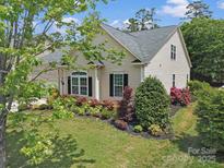Charming, one-story home with manicured landscaping and inviting curb appeal under a blue sky at 7123 Meyer Rd, Fort Mill, SC 29715