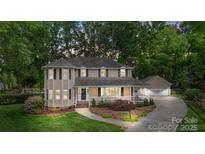 Charming two-story home with a welcoming porch and beautifully landscaped front yard at 8214 Coristar Pl, Huntersville, NC 28078
