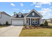 Charming home with a two-car garage, neat landscaping, and a welcoming entrance for an inviting curb appeal at 124 Canary Ln # 7, Mooresville, NC 28115