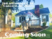Charming single-story home featuring a cozy porch, landscaped yard, and a classic brick chimney at 268 Jefferson Ne Ct, Concord, NC 28025