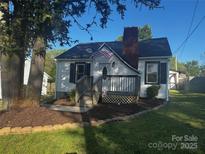 Charming single Gathering home with inviting porch, landscaped yard, and American flag at 268 Jefferson Ne Ct, Concord, NC 28025