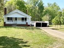 Charming white home with a cozy front porch and well-maintained lawn at 2724 Peachtree Rd, Statesville, NC 28625
