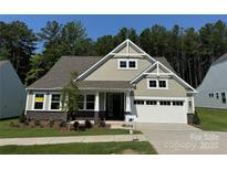 Charming single-Gathering home with well-maintained lawn, stone accents, and two-car garage at 3022 Cedar Falls Dr # 16, Waxhaw, NC 28173